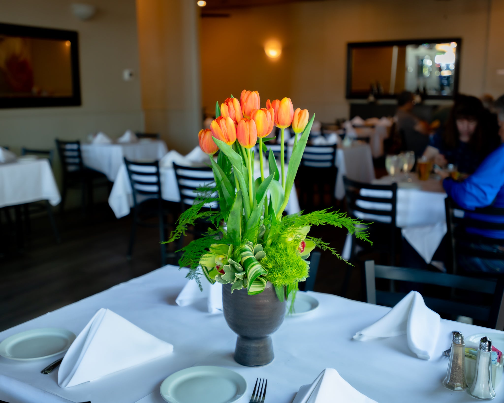 Brimful cymbidiums, 2 bunches of loose tulips, ceramic container