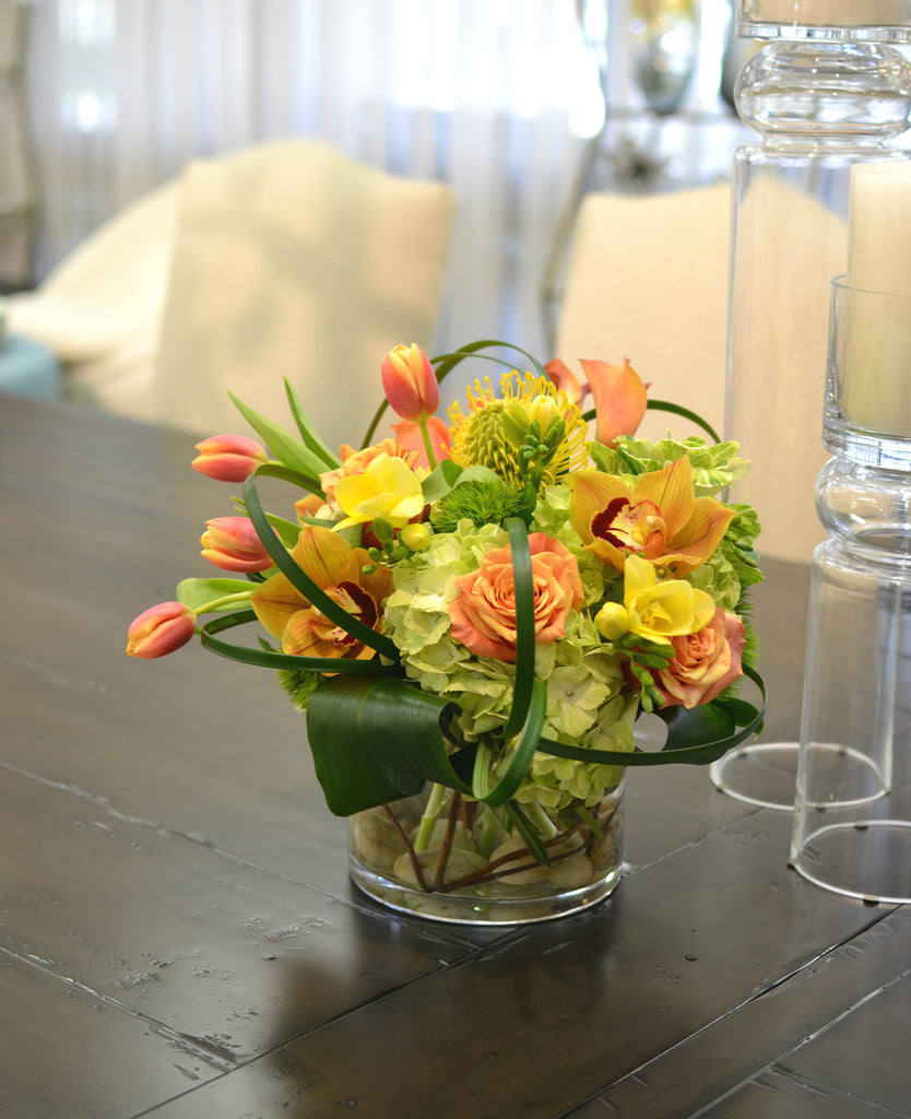 Lush & brimful, coiled foliage, circular vase with curly willow & rocks