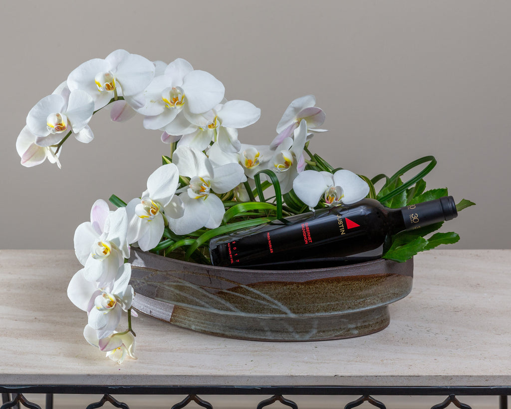 Orchids & foliage, Arakawa designer container, complimentary bottle of wine