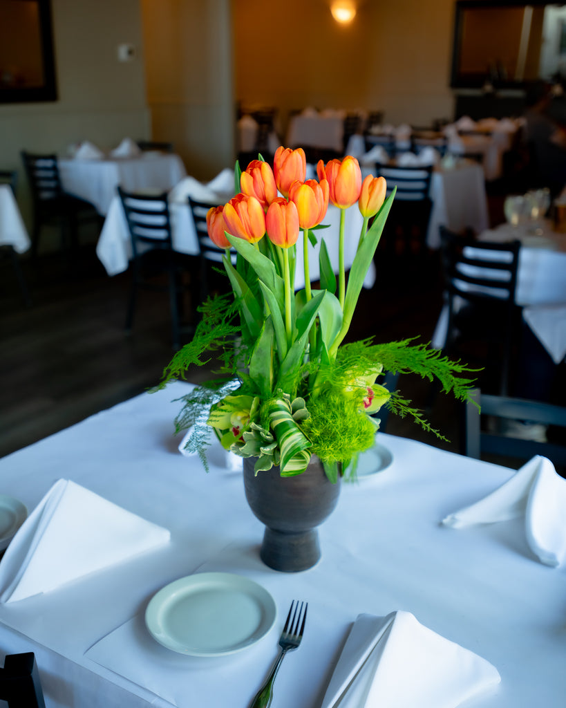 Brimful cymbidiums, 2 bunches of loose tulips, ceramic container