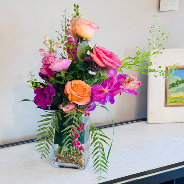 Compact and eclectic floral mix, rectangle glass vase