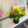 Sunflower dominant, clustered foliage, black ceramic container