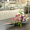Spilling floral orb in textured metal vessel bathed in a silver finish