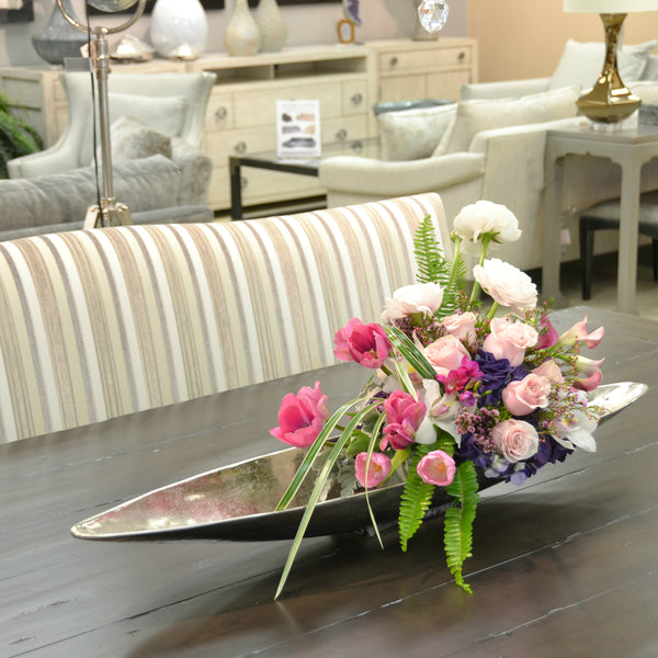 Spilling floral orb in textured metal vessel bathed in a silver finish