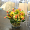 Lush & brimful, coiled foliage, circular vase with curly willow & rocks