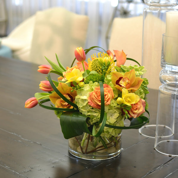 Lush & brimful, coiled foliage, circular vase with curly willow & rocks